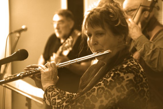 Artistic photograph of a flute trio performing