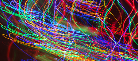 Long-exposure photograph of streaking coloured lights