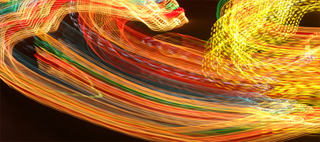 Long-exposure photograph of streaking coloured lights