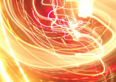 Long-exposure photograph of streaking coloured lights